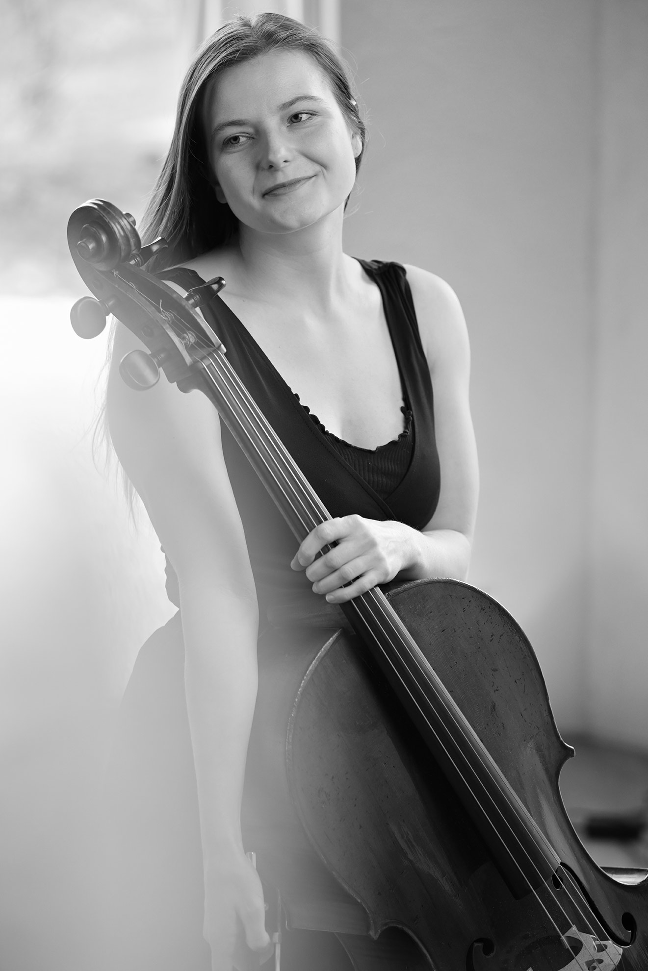 Black-and-white portrait of a wedding and events cellist